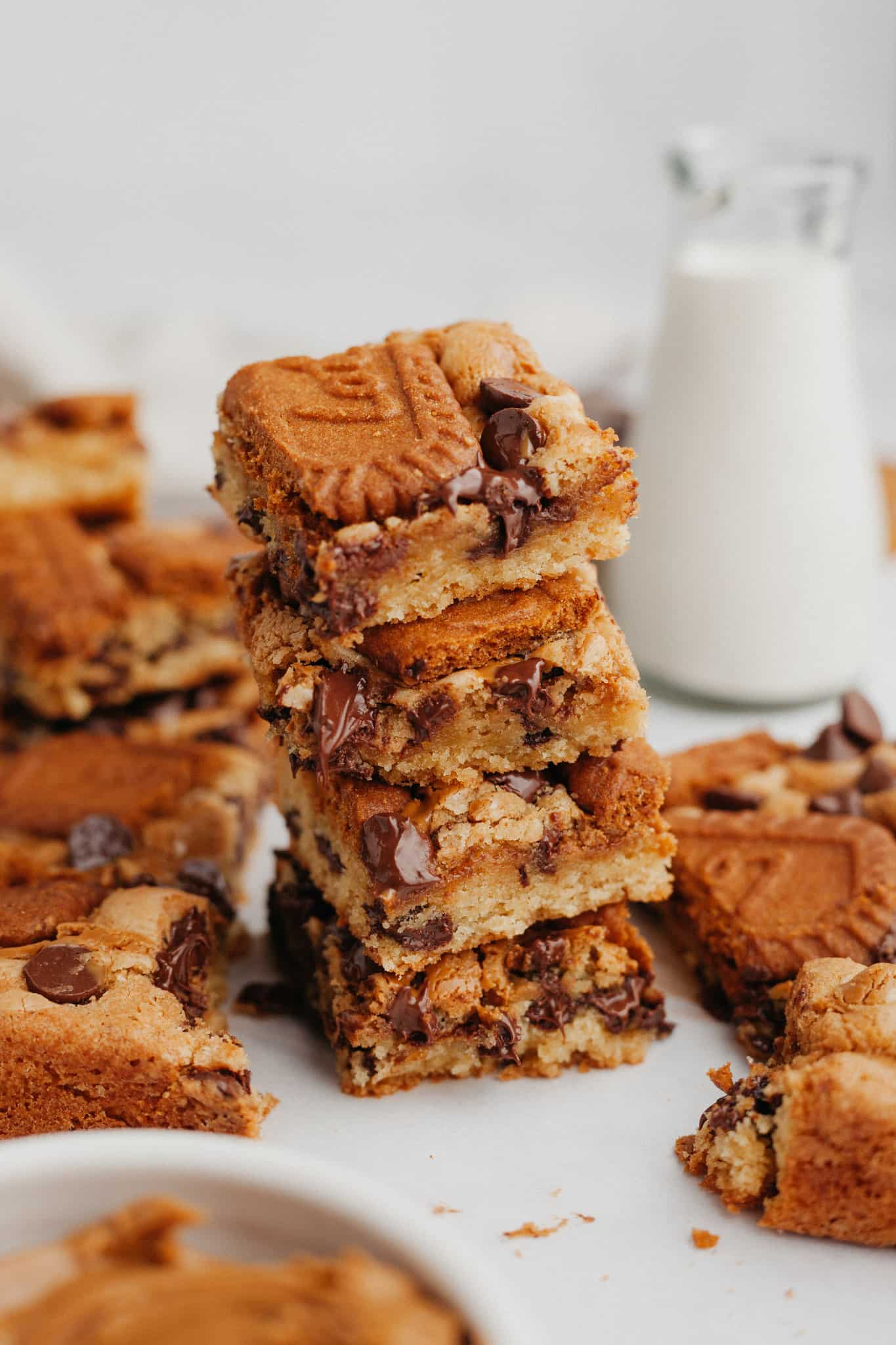A stack of 4 Biscoff blondies on parchment paper.