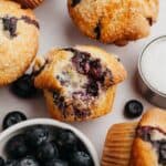 A close up of a blueberry muffin with a bite taken out of it.