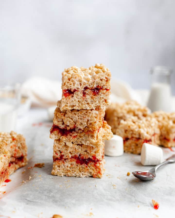 a stack of three peanut butter and jelly rice krispie treats