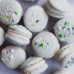 tin full of eggnog macarons with sprinkles on top