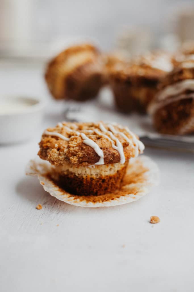 a cinnamon roll muffin with the baking base pulled down
