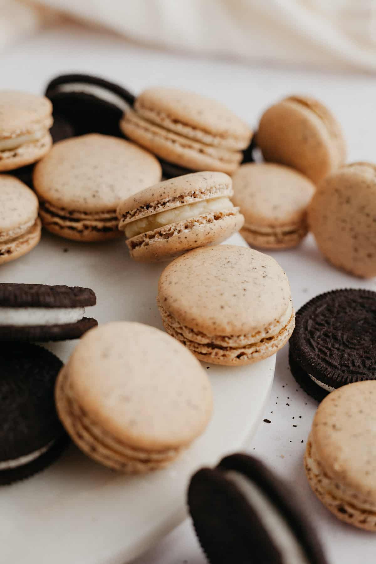 several oreo macarons along with oreo cookies