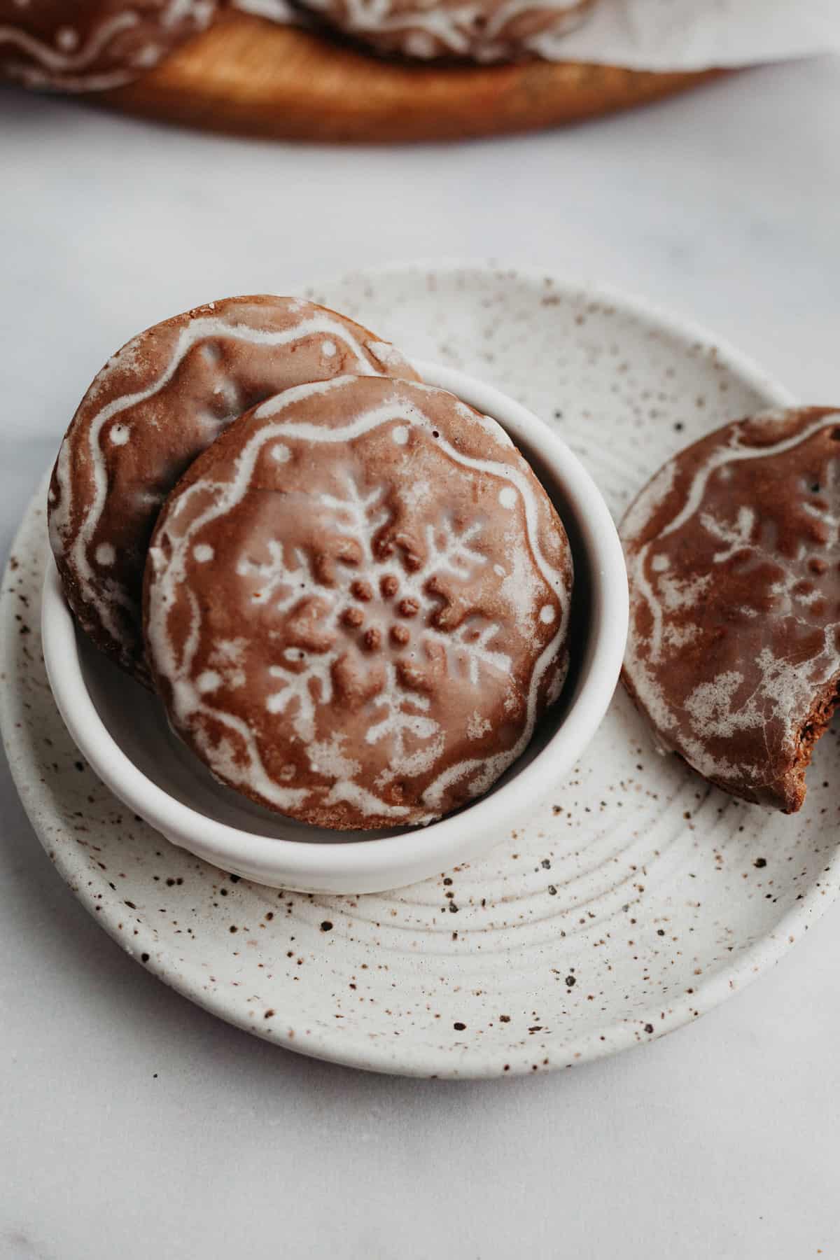 Two snowflake stamped lebkuchen cookies in a small bowl.