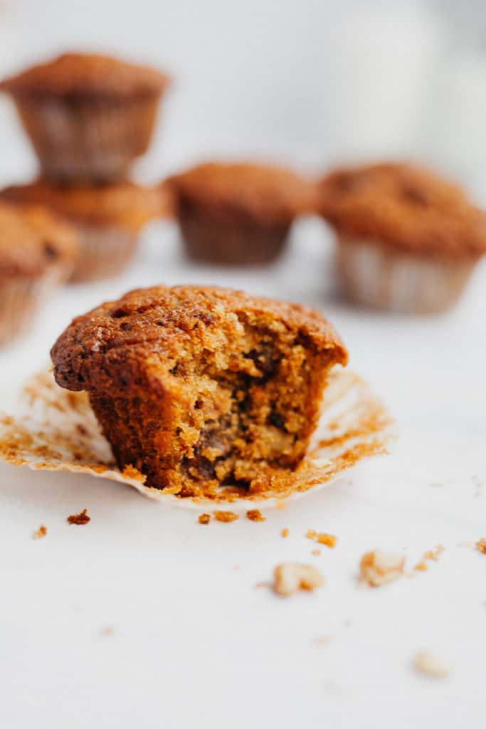 an apple and carrot muffin with a bite taken out of it