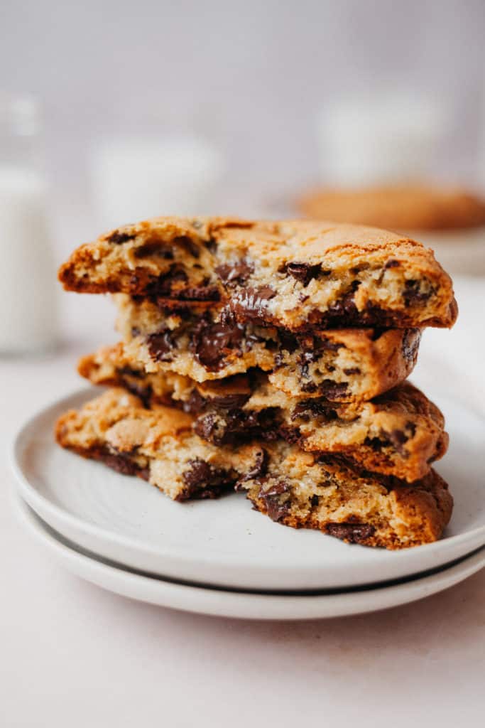 4 halves of chocolate chip cookies stacked on a small plate