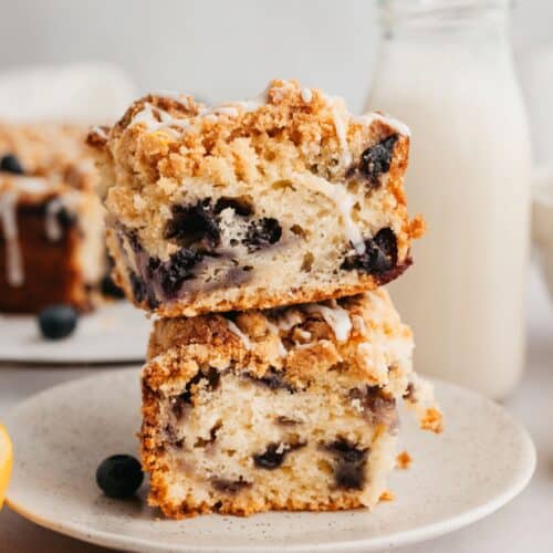 A stack of two slices of crumb topped blueberry coffee cake.