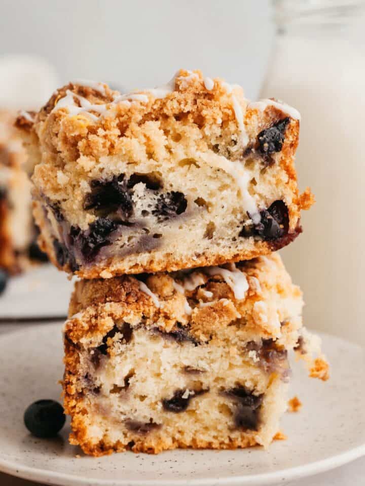 A stack of two slices of crumb topped blueberry coffee cake.