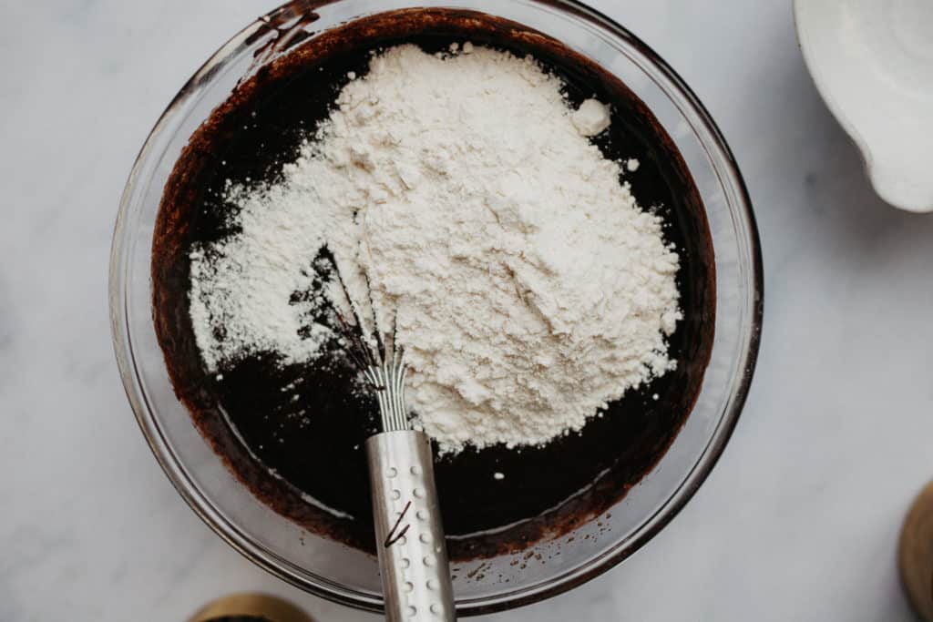 Overhead view of brownie batter with flour on top