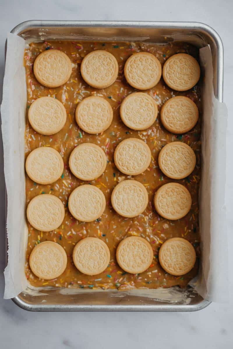 Unbaked funfetti bars with golden oreos on top