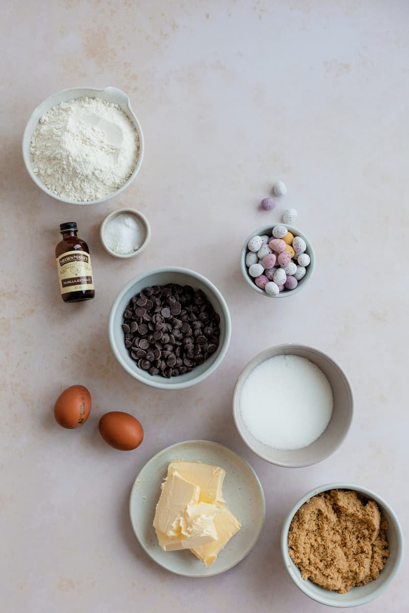 All the ingredients needed for mini egg cookies, in their own small bowls.