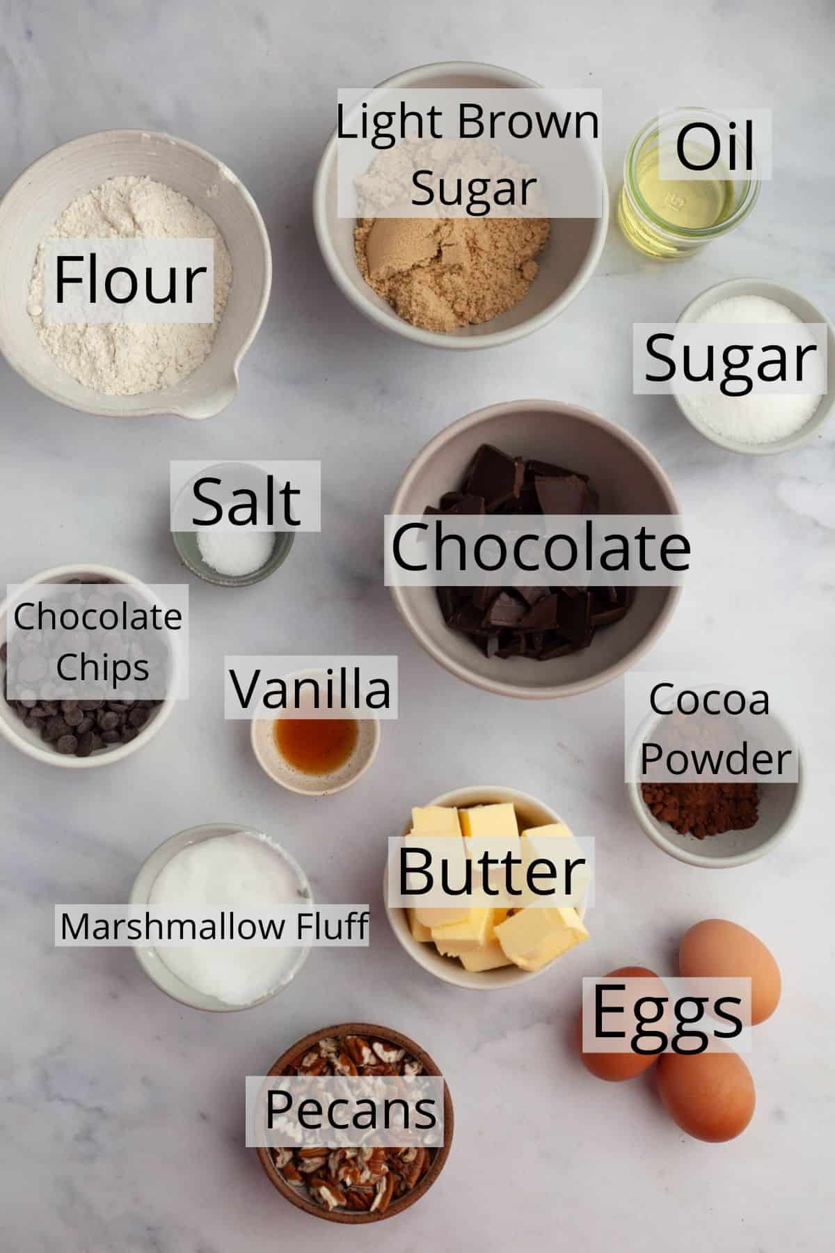 All the ingredients needed for marshmallow fluff brownies weighed out into small bowls.