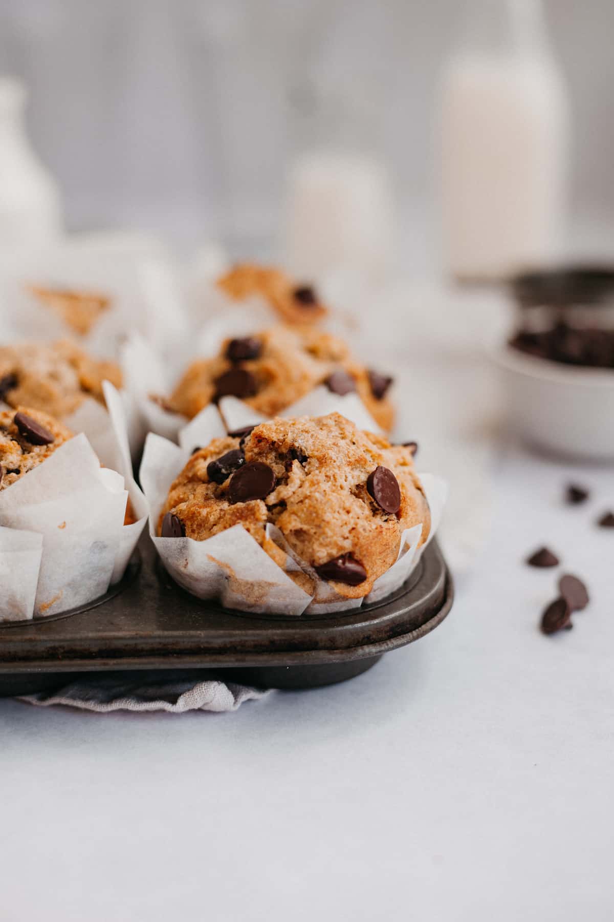 banana oatmeal muffins with chocolate chips in a dark muffin pan