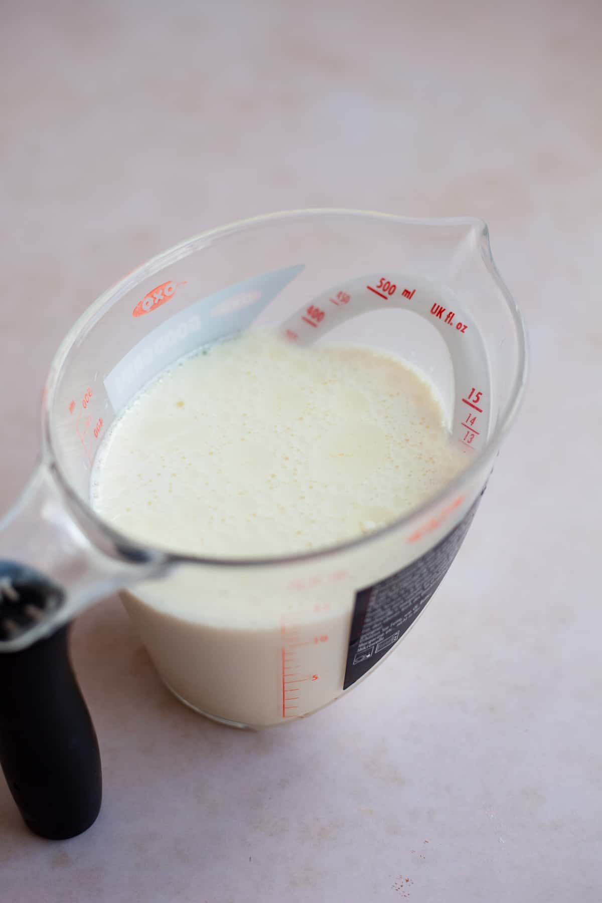 Milk and yoghurt mixed together in a small plastic pyrex jug