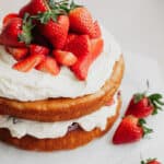 A strawberry filled cake on parchment paper