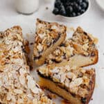 Three slices of blueberry crumb cake with flaked almonds on top