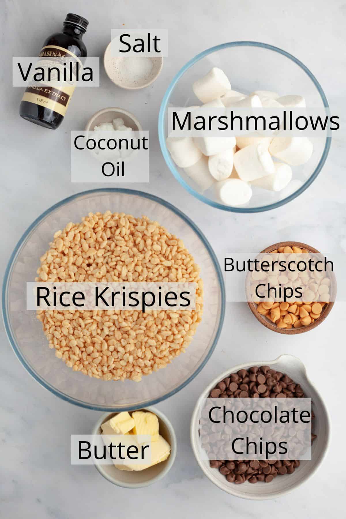 Ingredients needed to make chocolate covered rice krispie treats weighed out into small bowls.