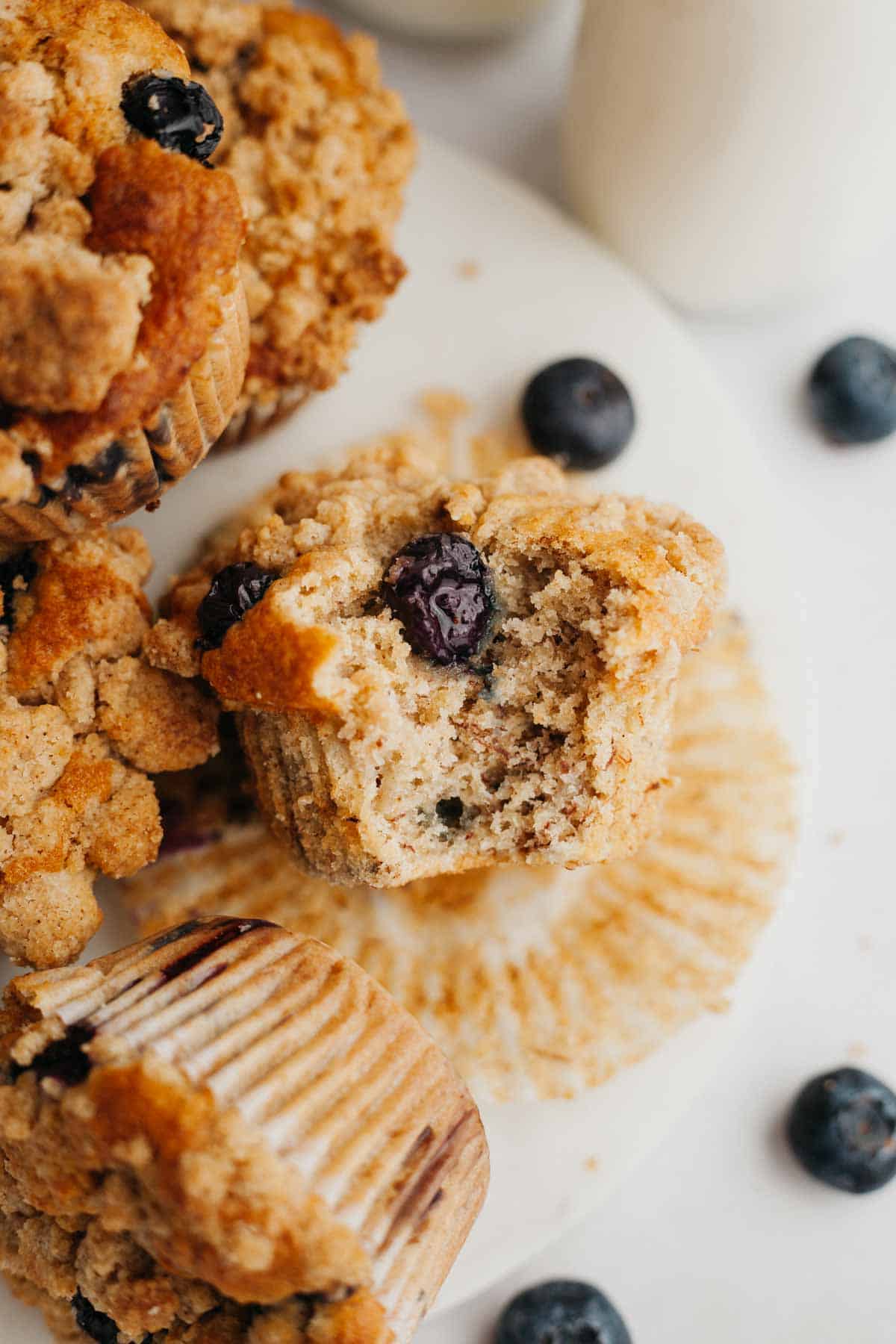 A close up of a blueberry muffin with a bite taken out of it.