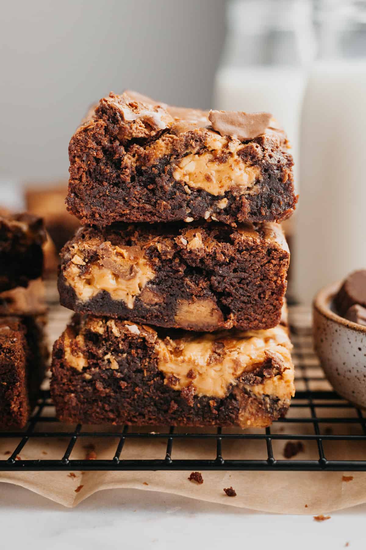 A stack of three brownies with peanut butter cups.