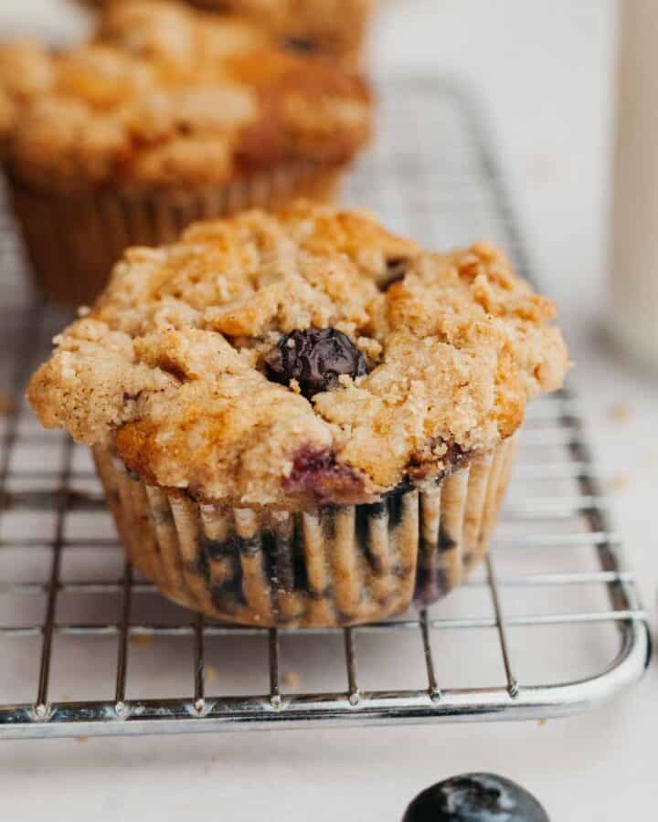 a blueberry muffin on a small cooling rack.