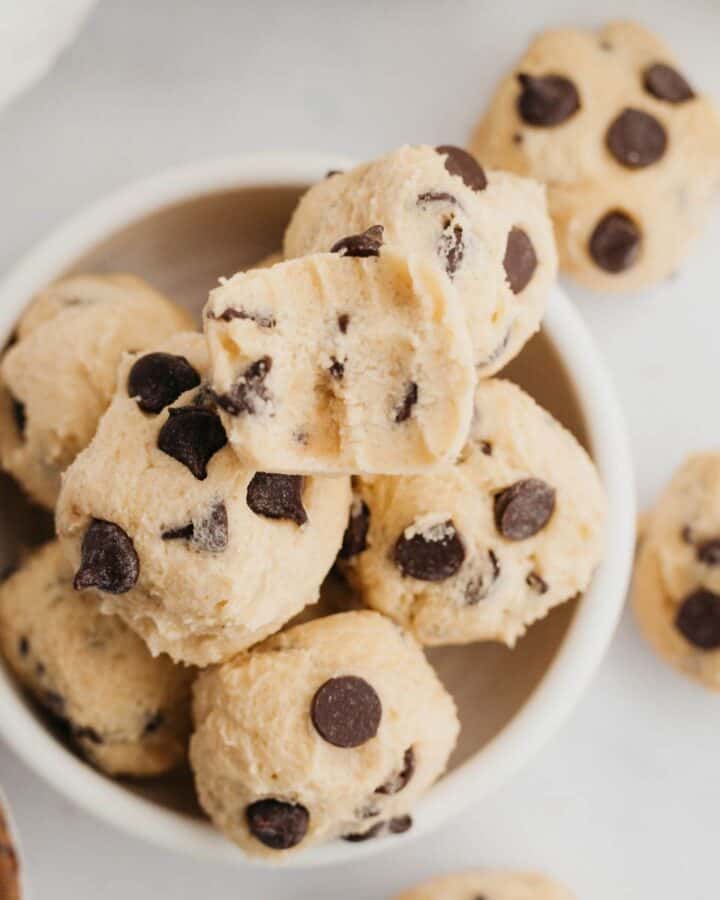 no bake chocolate chip cookie dough bites in a small ceramic bowl.