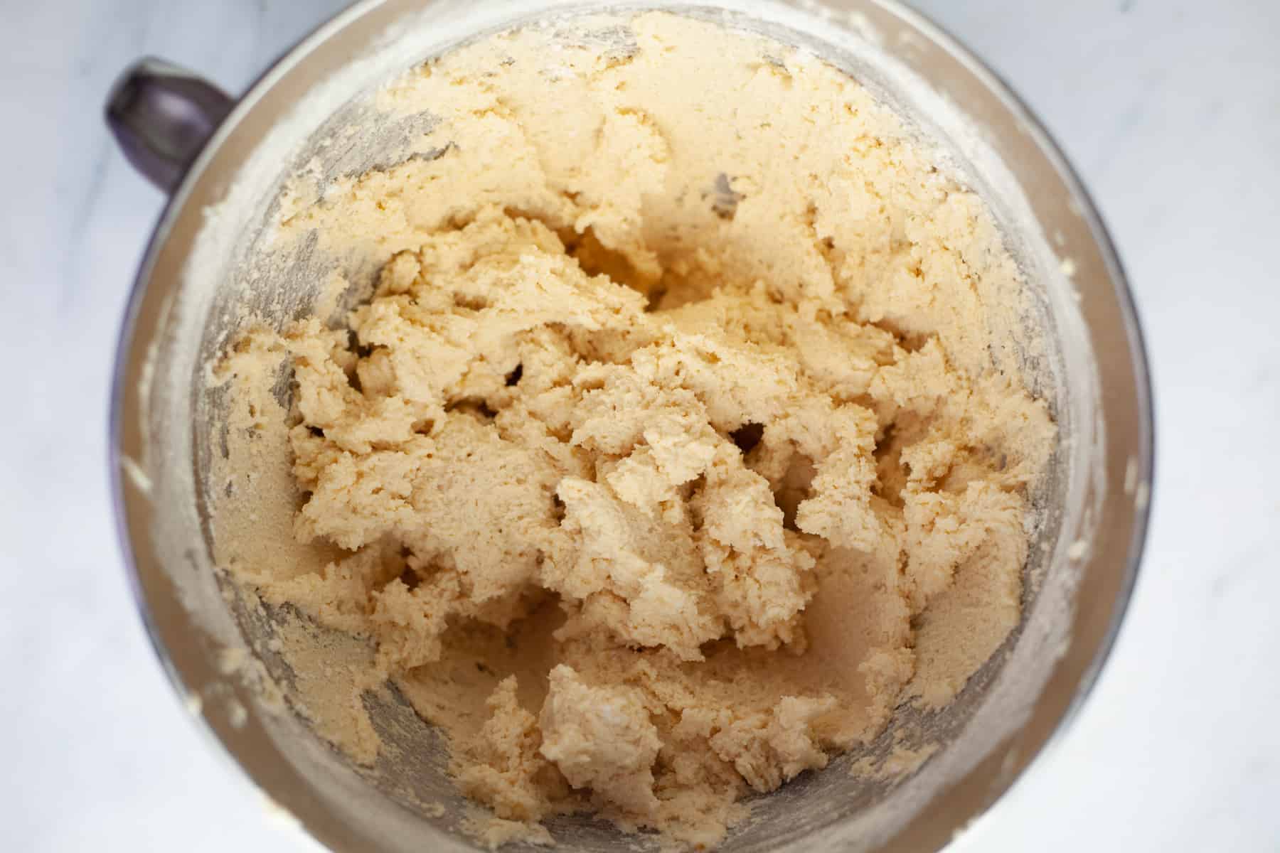 Overhead shot of sugar cookie dough in a large mixing bowl