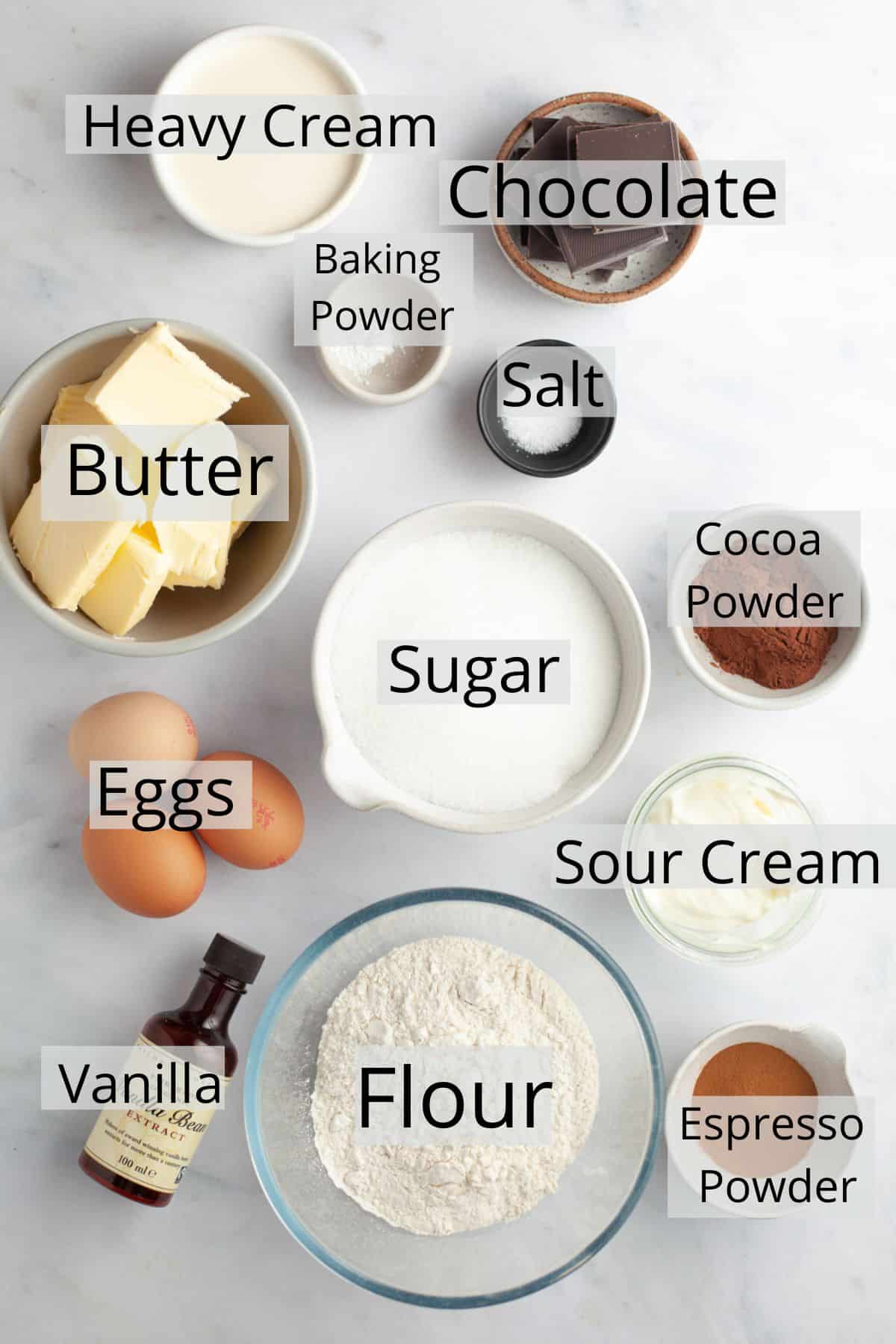 All the ingredients needed to make marble loaf cake weighed out into small bowls.