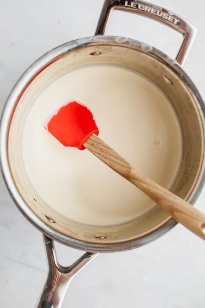 heavy cream in a silver saucepan