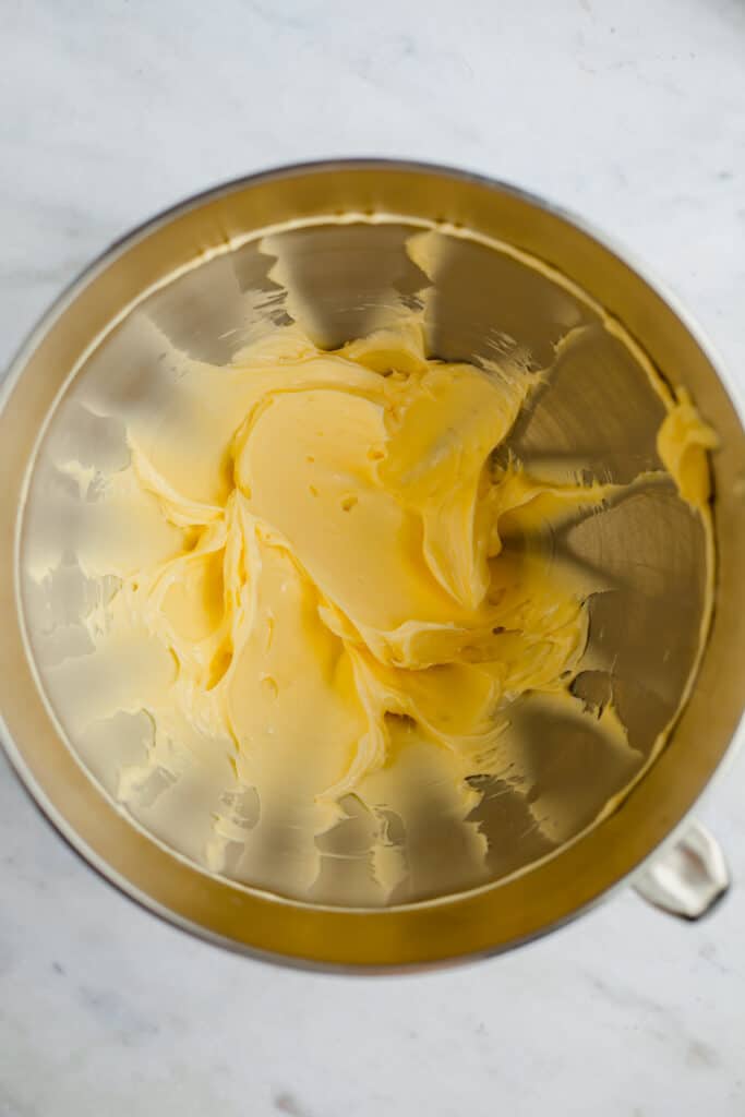 A silver mixing bowl with creamed butter