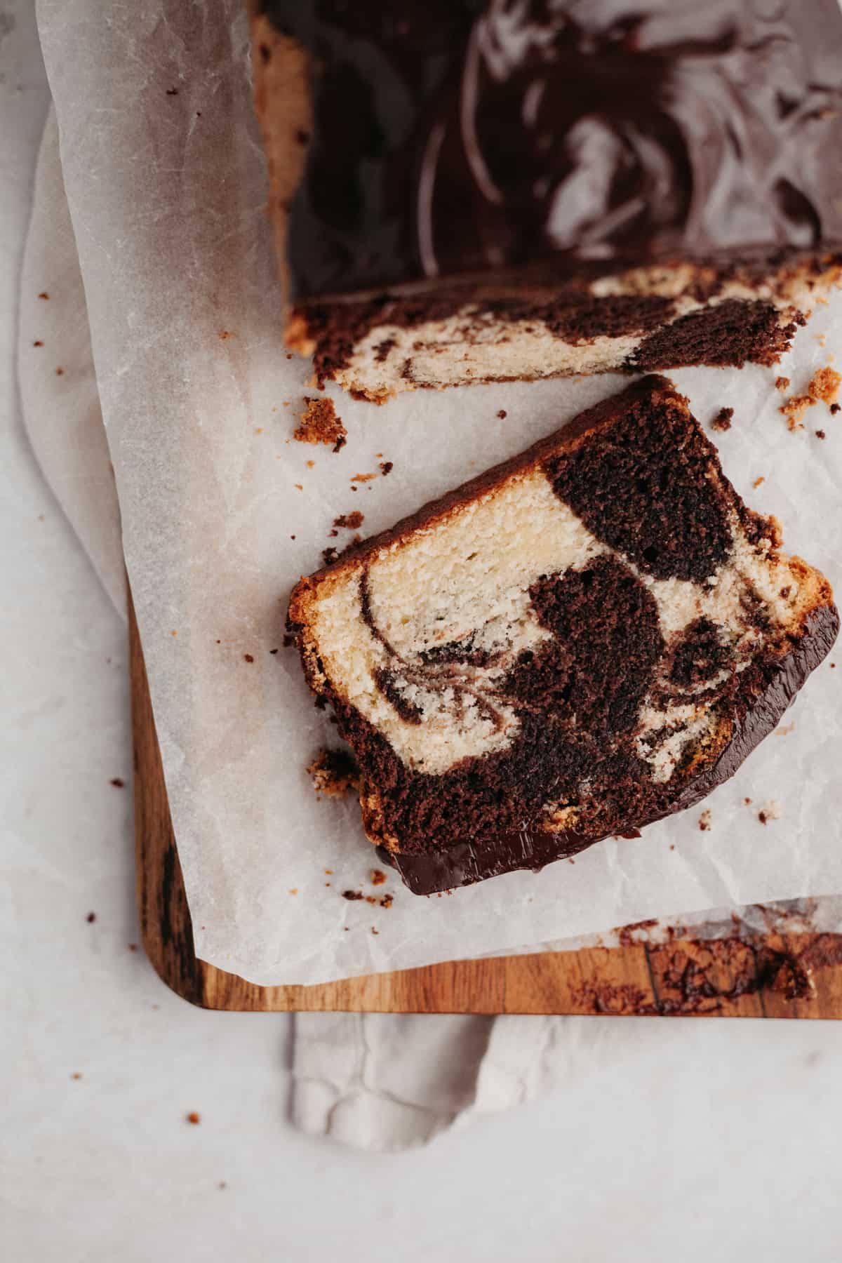 A slice of marble pound cake on parchment paper
