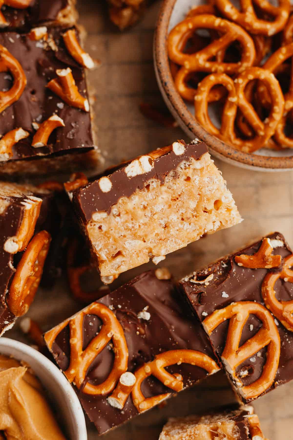 Peanut butter chocolate rice krispie treat squares, topped with pretzels.