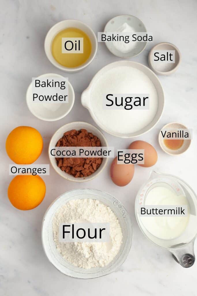All the ingredients needed to make a chocolate orange cake, weighed out into small bowls.