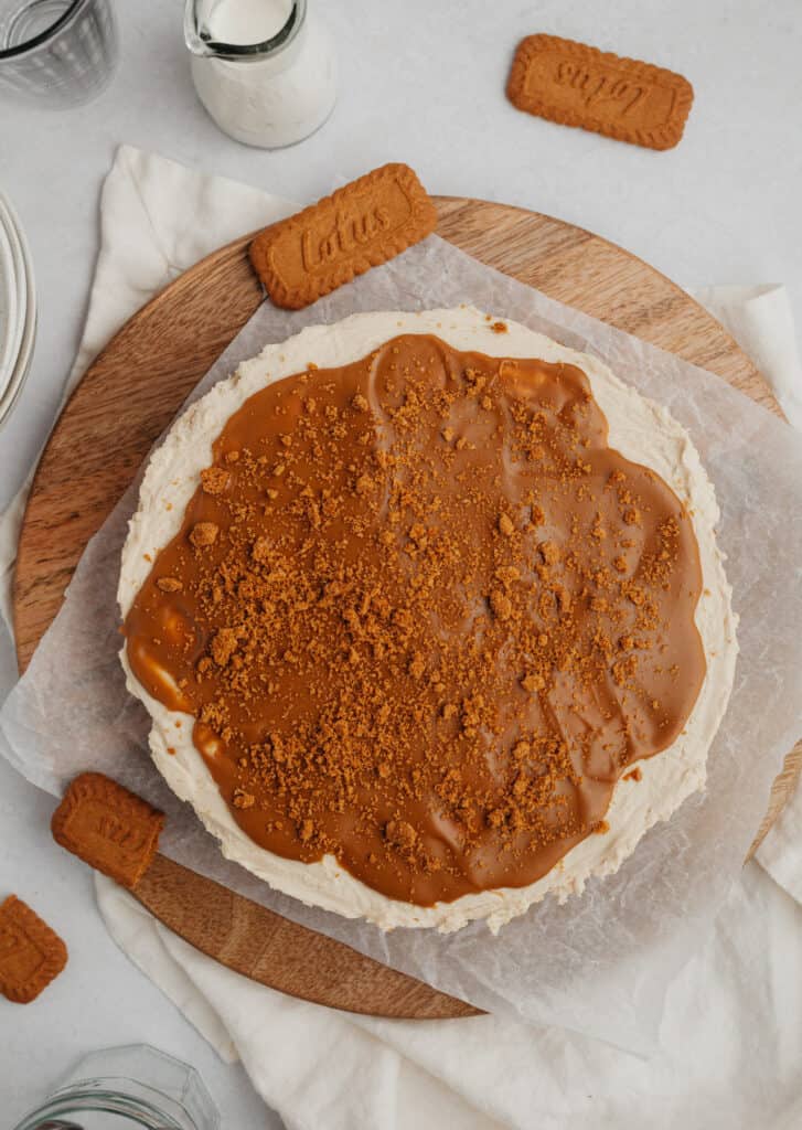 Overhead shot of biscoff cheesecake on a circular wooden board