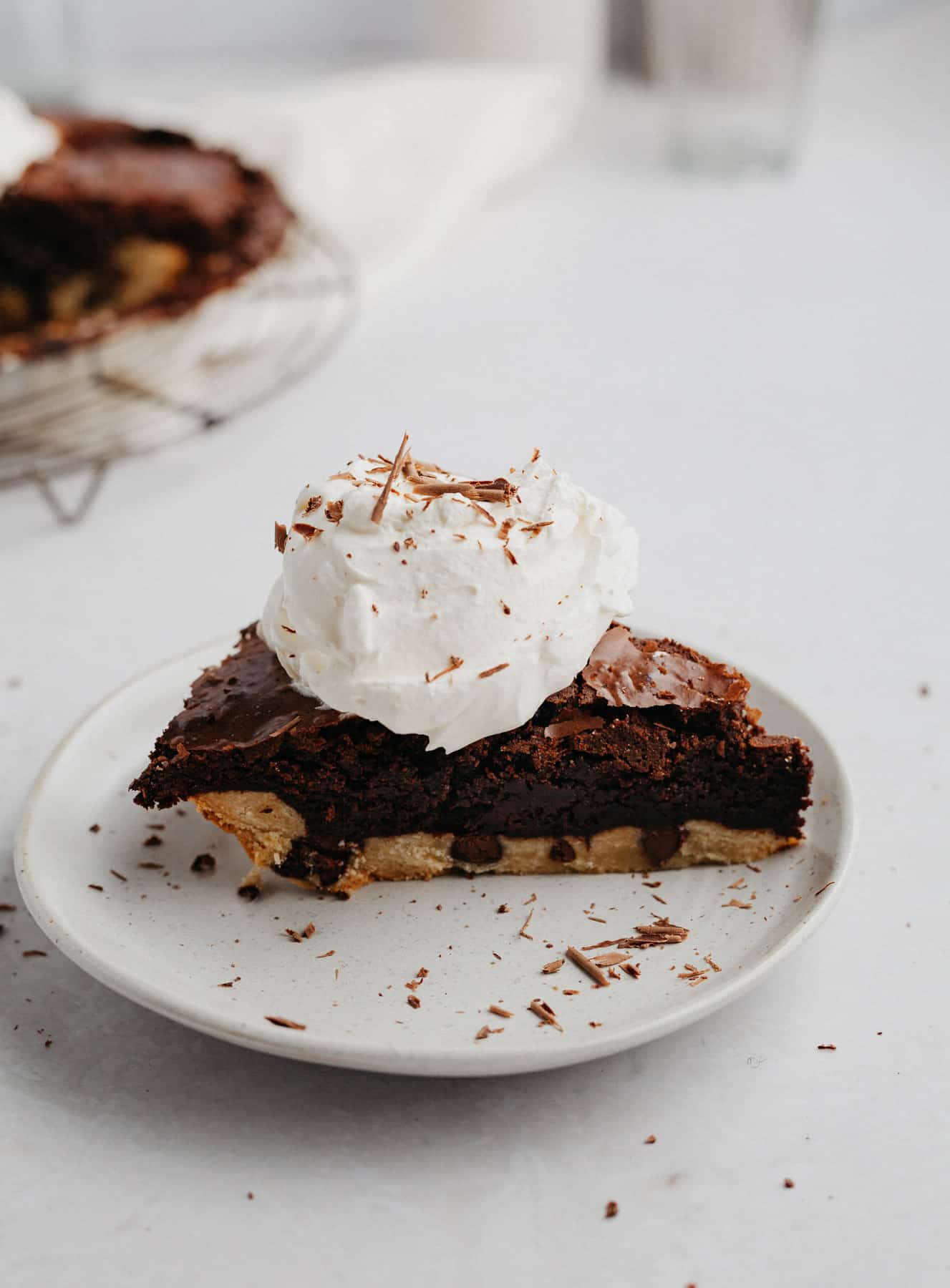 A slice of brownie pie with a dollop of whipped cream