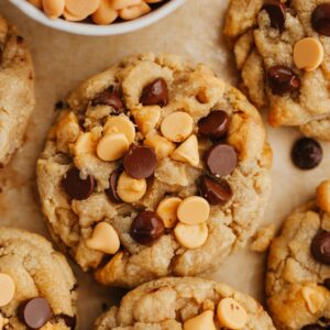 Chocolate chip butterscotch cookies on parchment paper.