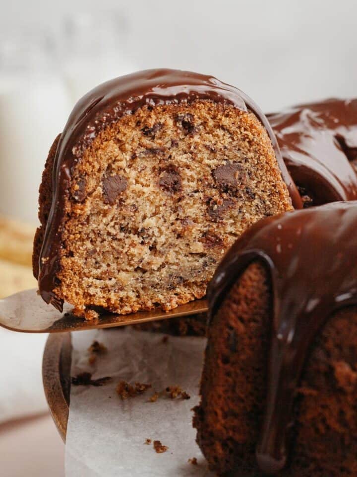 A slice of bundt cake being lifted out with a cake server.
