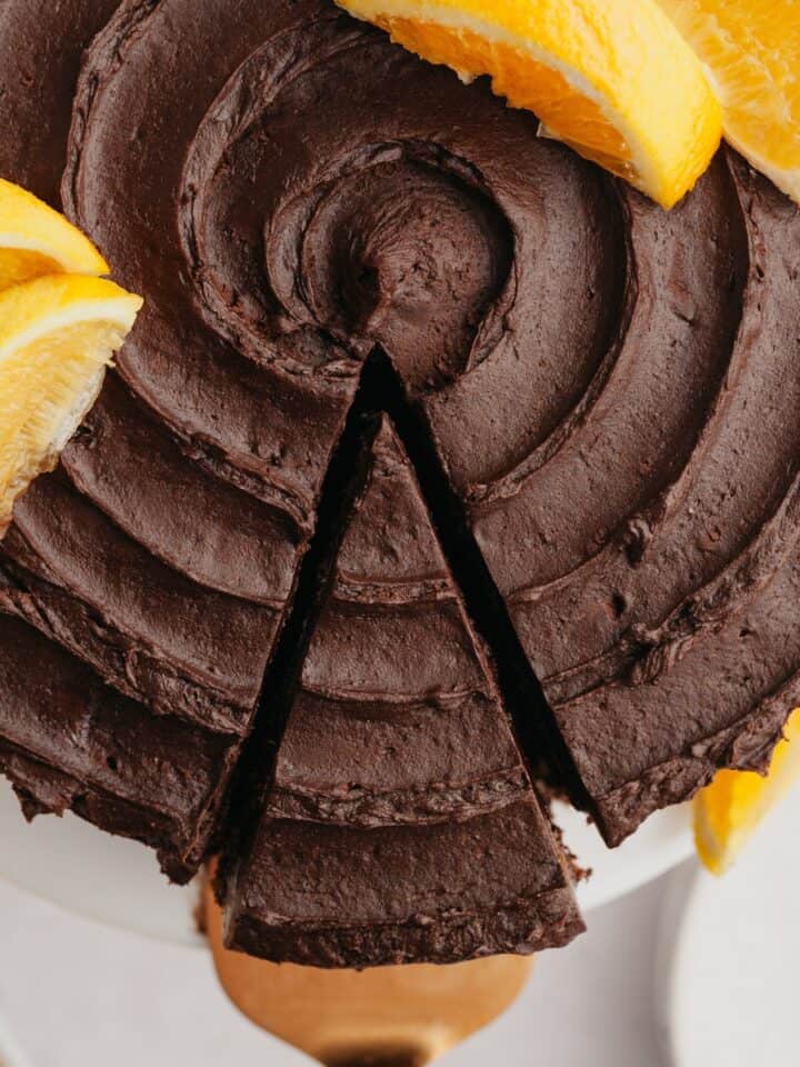 An overhead shot of a slice of chocolate cake being removed from the cake.