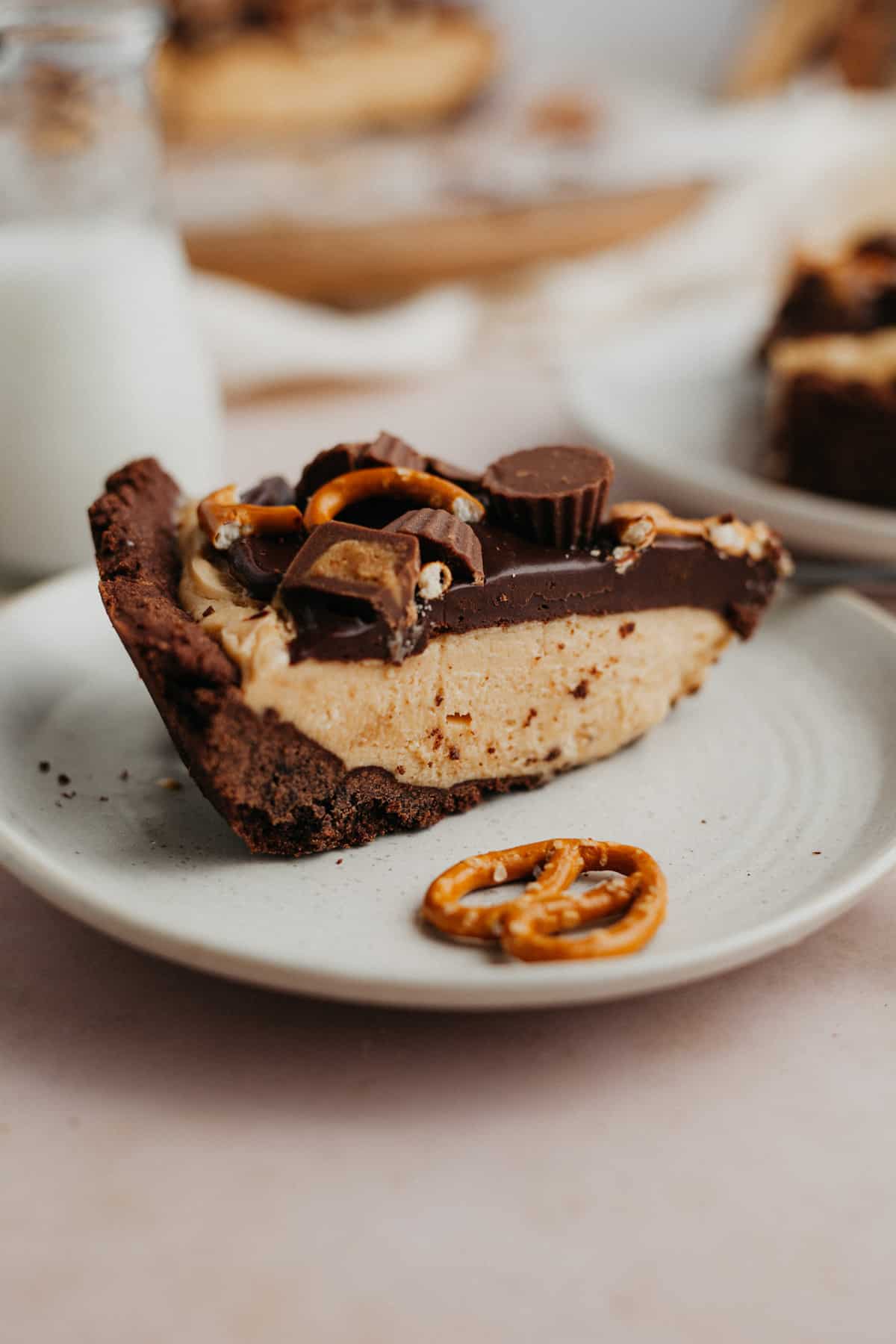 a slice of no bake peanut butter chocolate pie on a small plate.