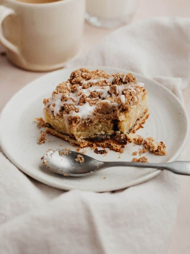 a square slice of chai coffee cake on a small beige plate