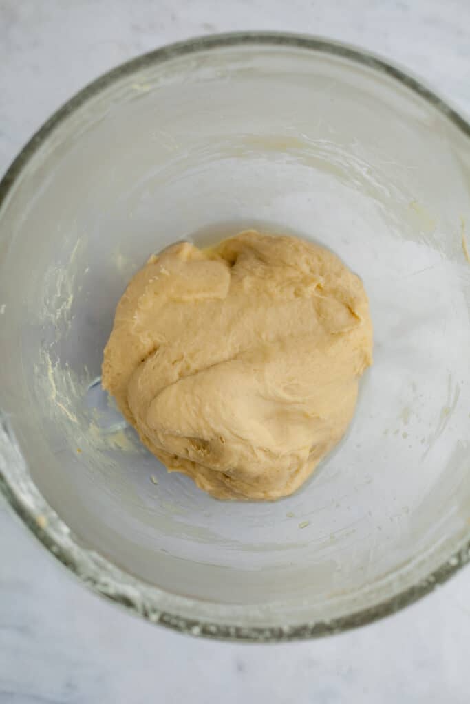 cinnamon bun dough in a greased bowl