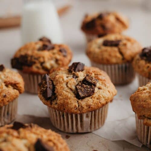 Peanut butter muffins with chocolate chunks on parchment paper