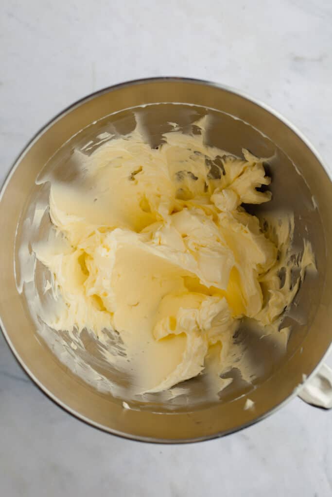 A metal mixing bowl with whipped butter and mascarpone