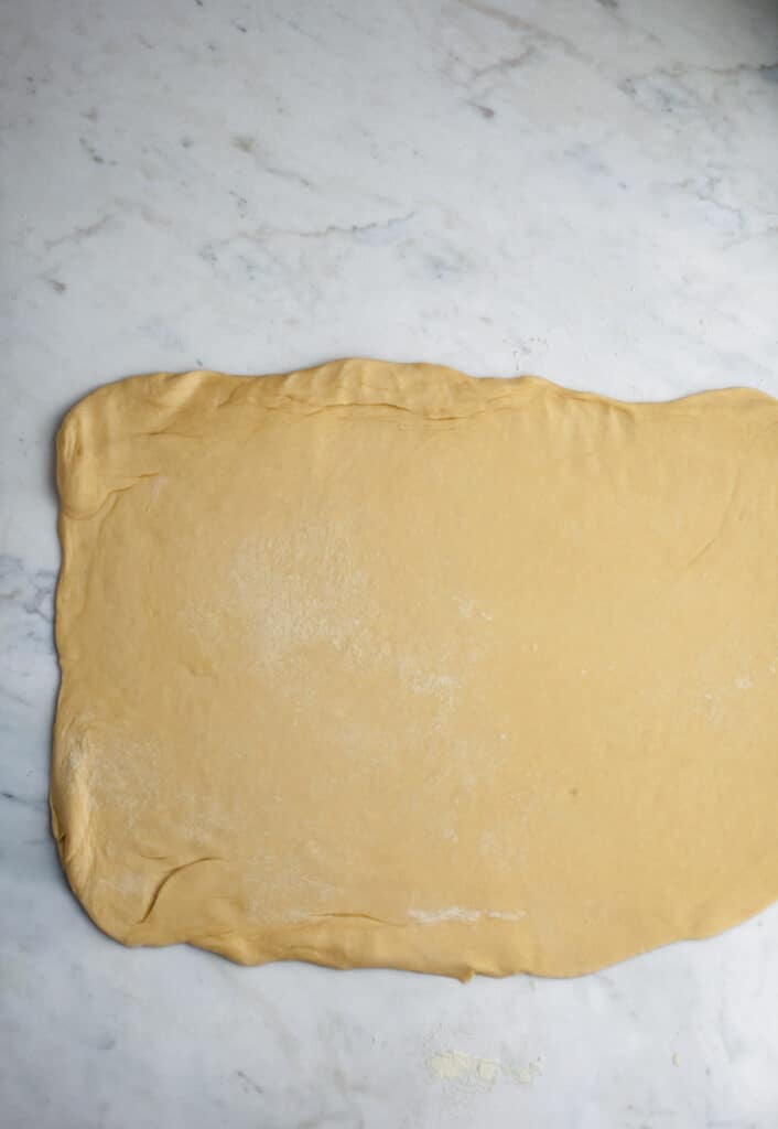 rolled out rectangular cinnamon bun dough