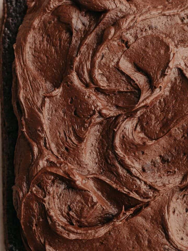 A square chocolate cake with chocolate frosting.