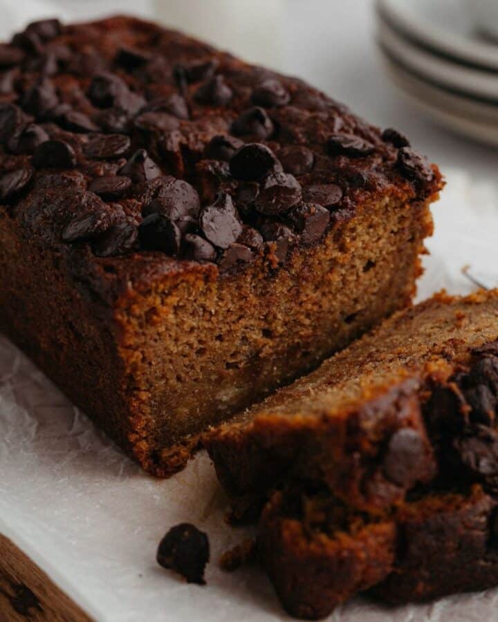 A close up of a pumpkin banana loaf with several slices cut