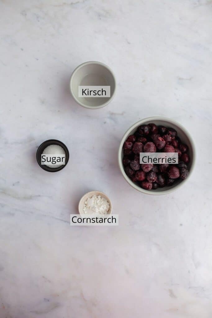 cherries, cornstarch, kirsch and vanilla weighed out in small bowls.