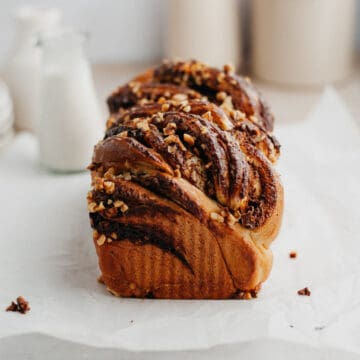 A baked nutella babka on parchment paper.