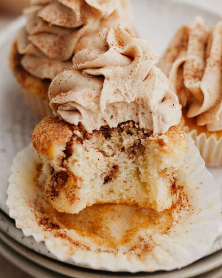 a cinnamon swirl cupcake with a bite taken out of it.