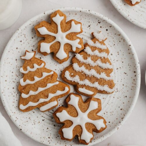Iced gingerbread cookies on a plate.