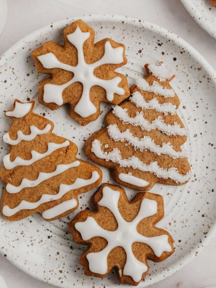 Iced gingerbread cookies on a plate.