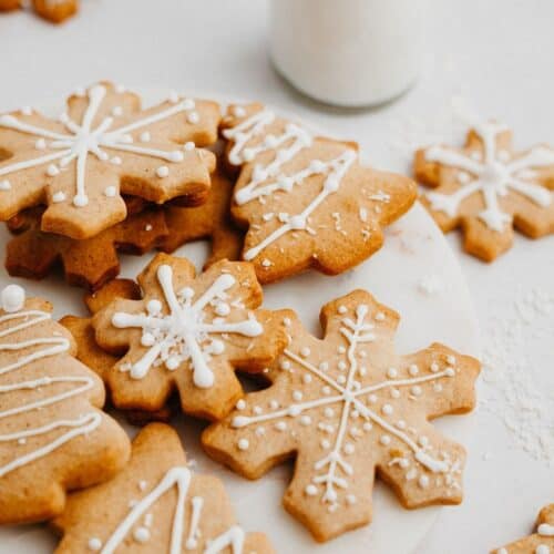 iced gingerbread cookies in the shape of snowflakes and christmas trees.
